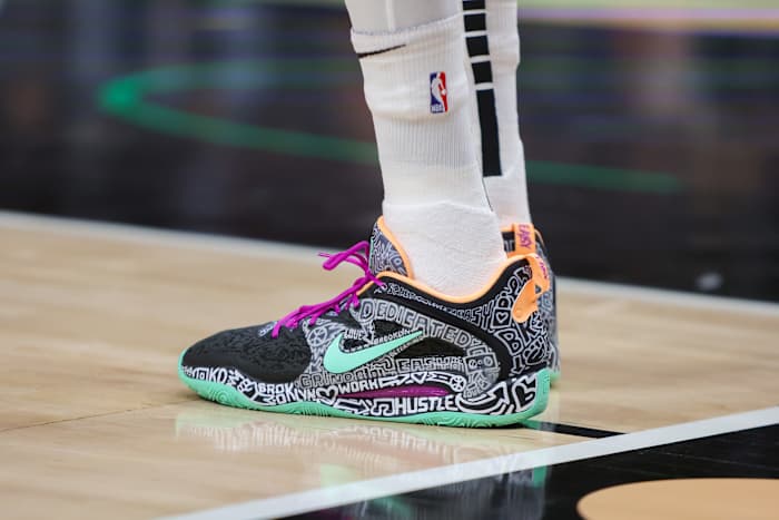 View of Kevin Durant's black and green Nike shoes.